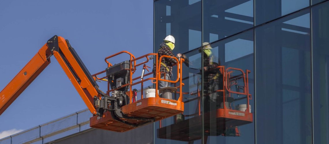Window installer on a commercial building